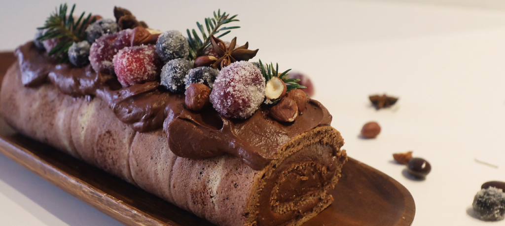 “chocolate-buche-de-noeal-decorated-with-sugared-berries-for-christmas-celebration”>"